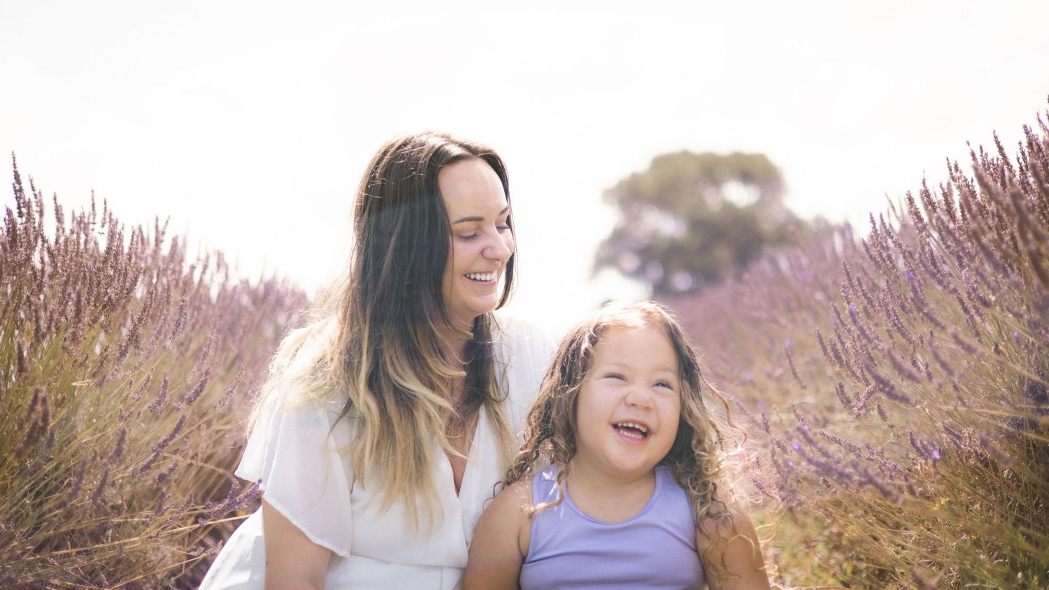 Family enjoying playful moments in a scenic lavender field.