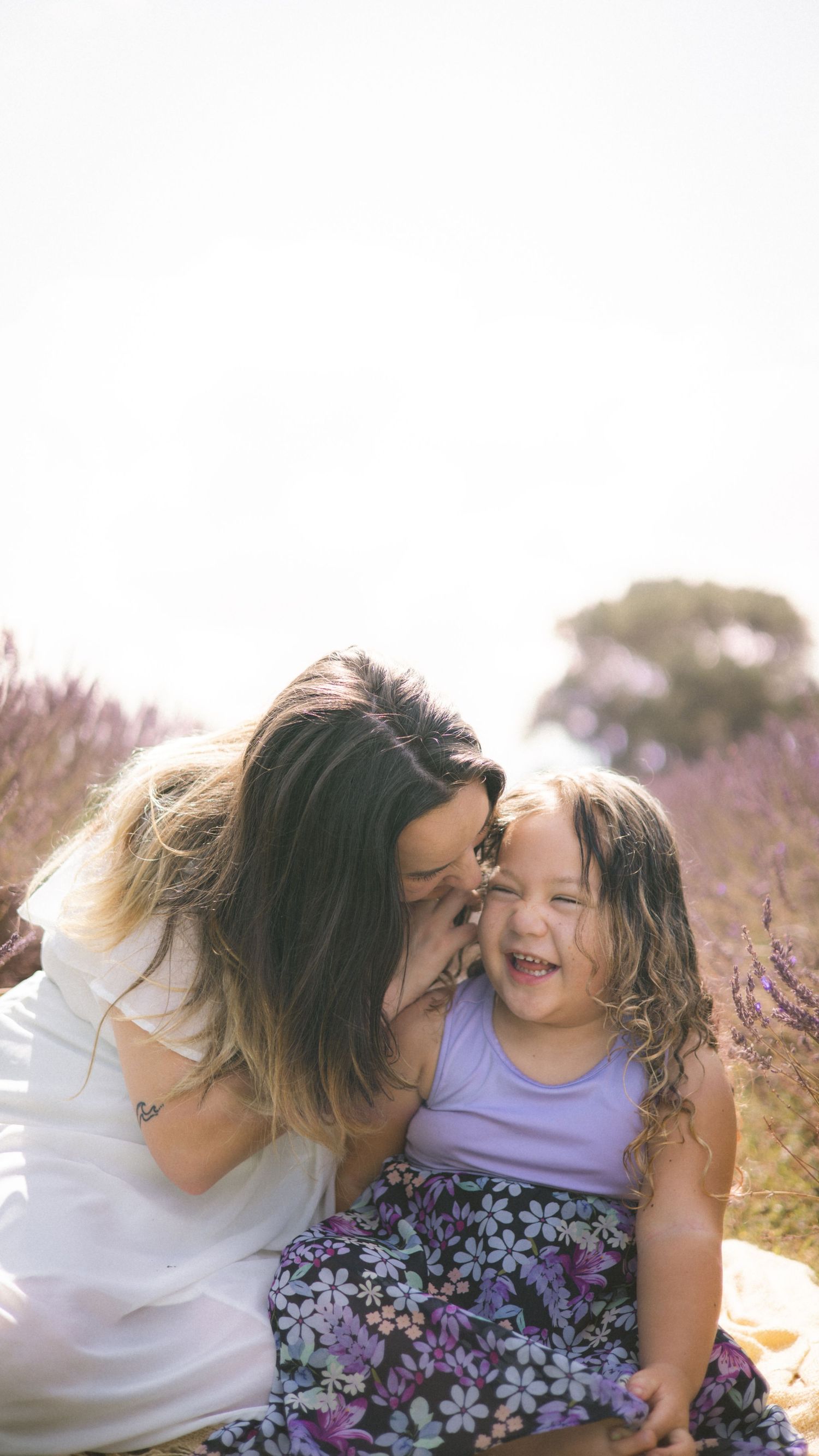 Sweet candid moments between family members in a lavendr field.