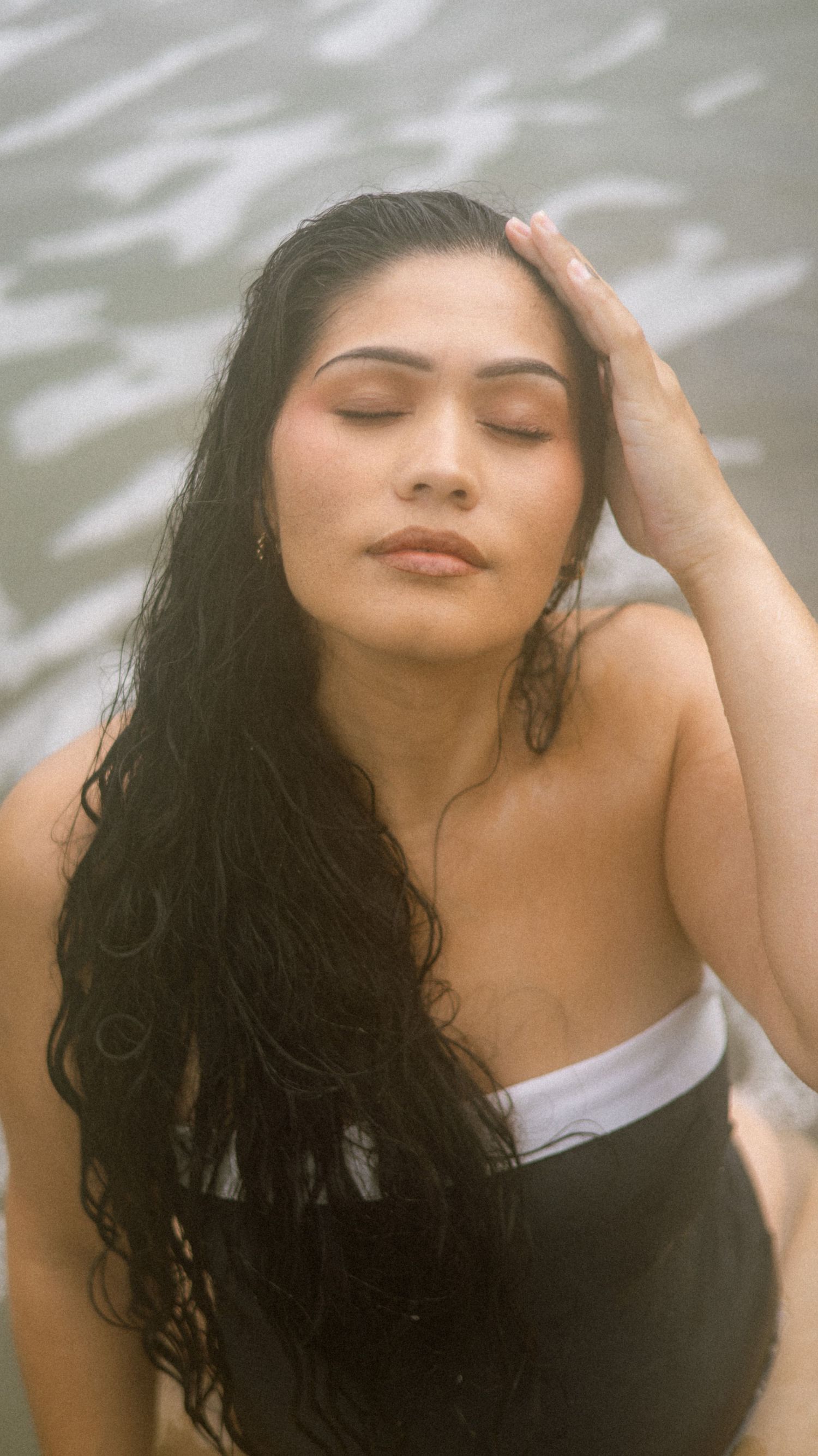 A series of artistic portraits showing someone with flowing dark hair in various graceful poses against a light background.