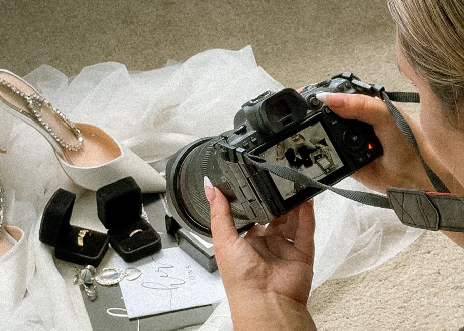 A sequence of hands using a camera to photograph sketches and drawings on white paper against a light carpet background.
