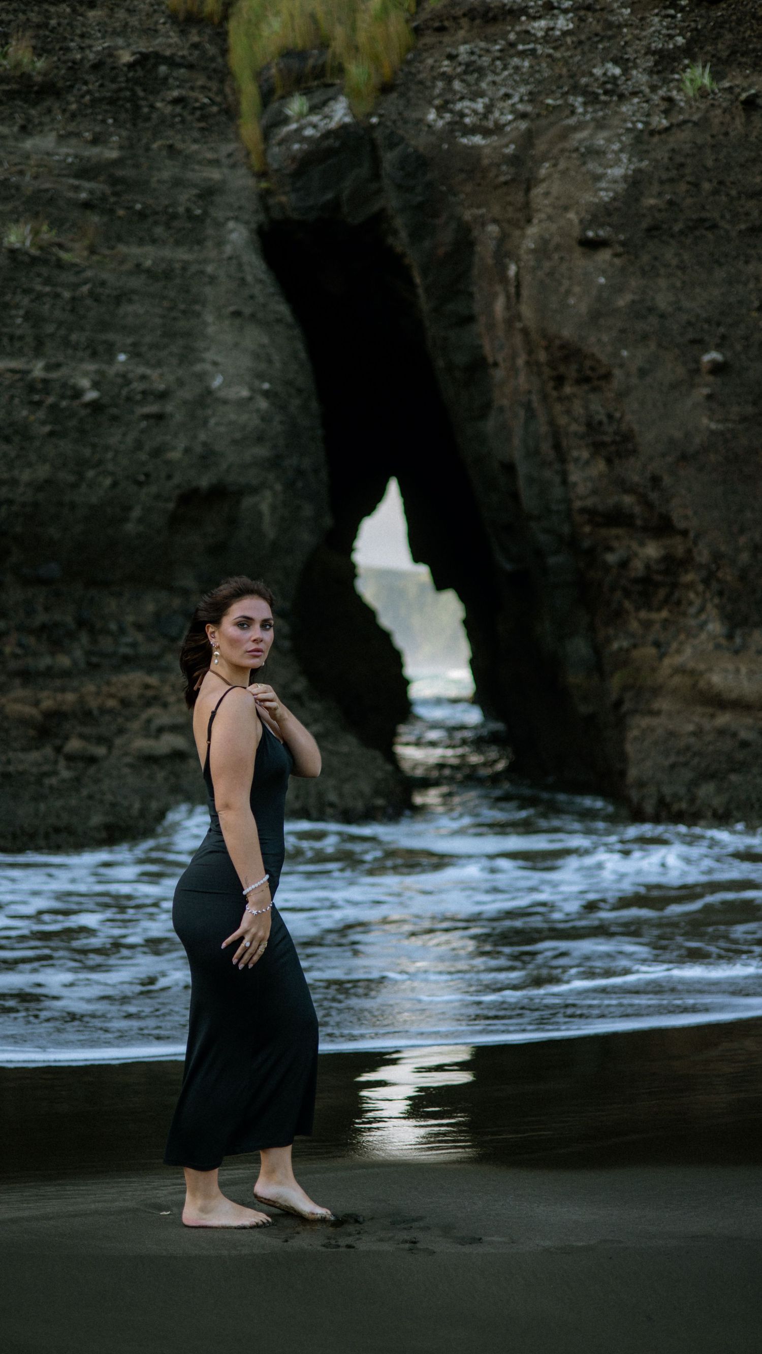 Artistic silhouette poses against dramatic coastal rock formations.