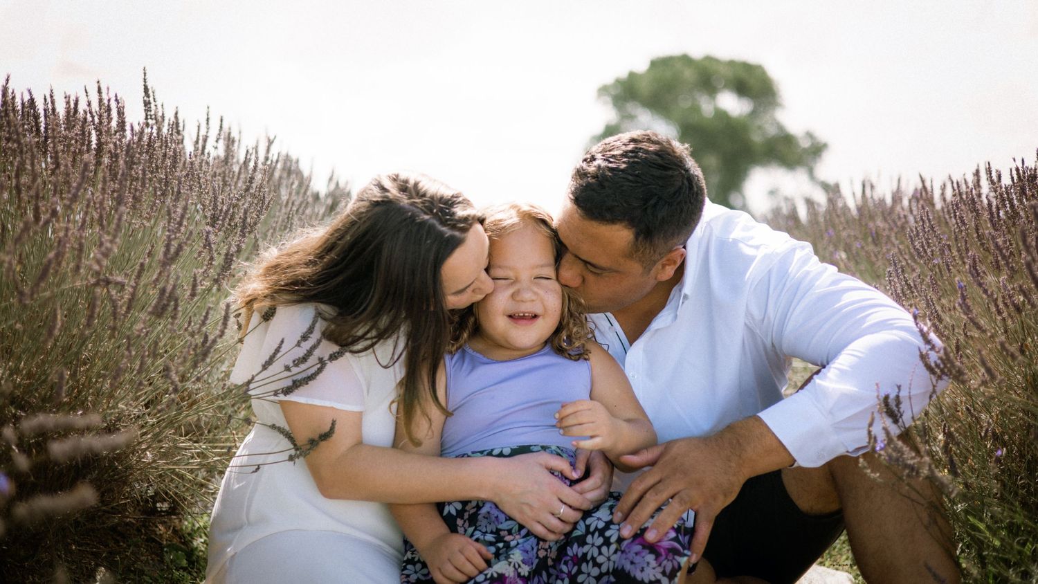 Loving family moment captured in a field of lavenders.