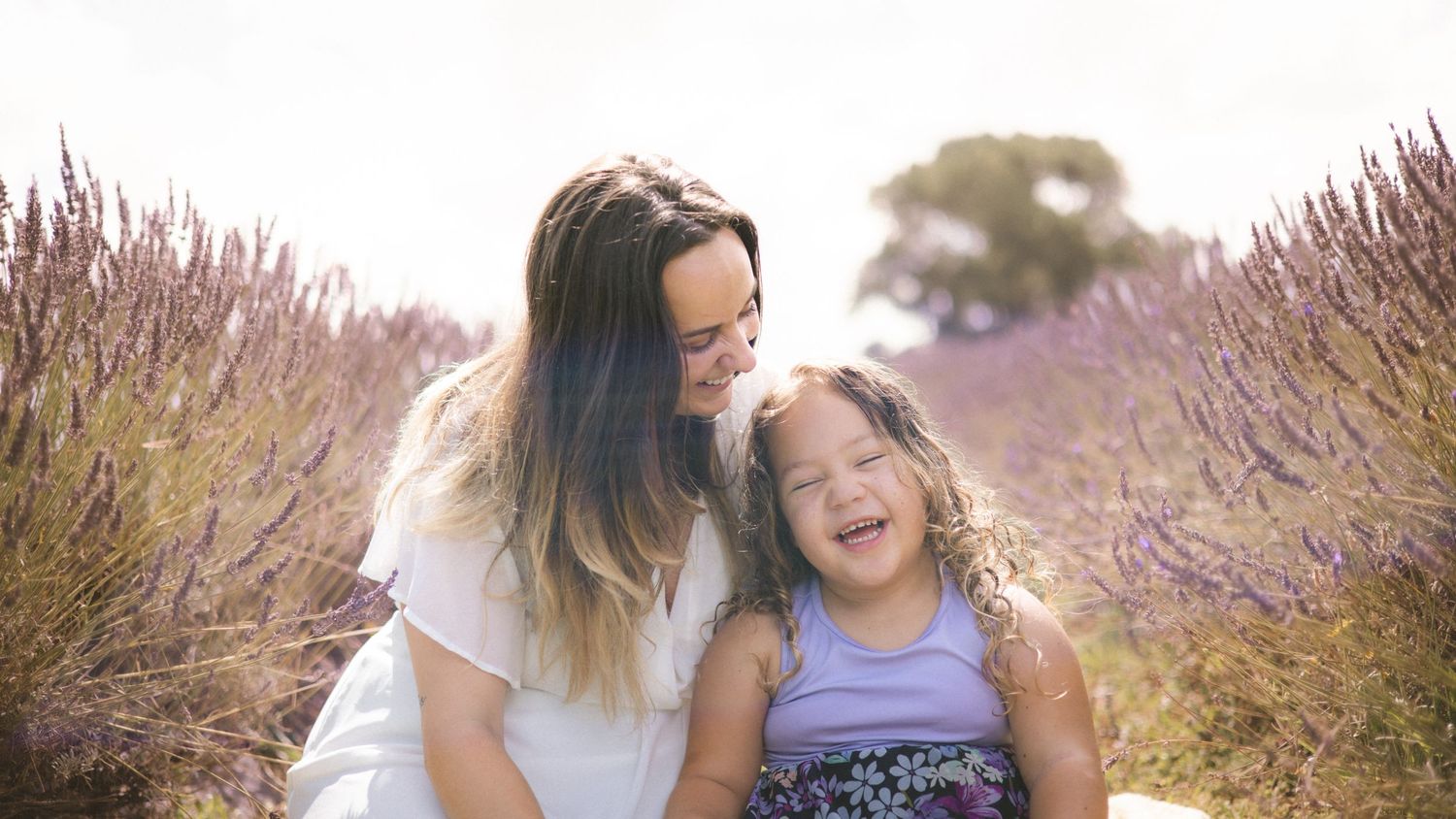 Tender family interactions photographed in a blooming lavender garden.