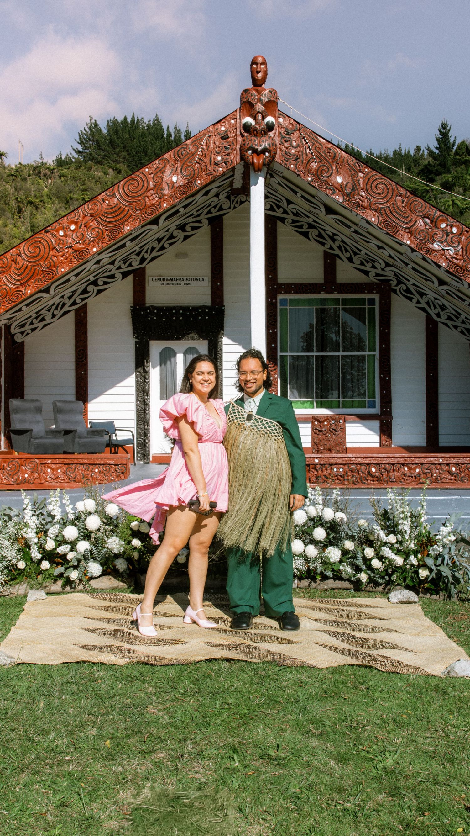 A series of four photos showing visitors sitting on the steps of a traditional Maori meeting house in New Zealand.