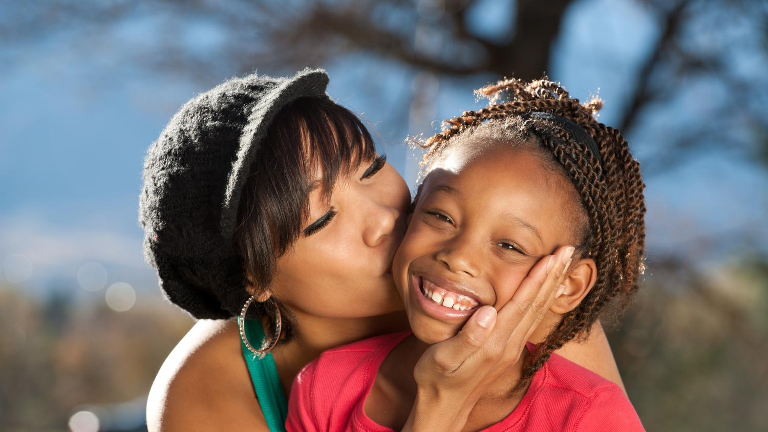 A tender moment between parent and child showing love and affection in outdoor settings.