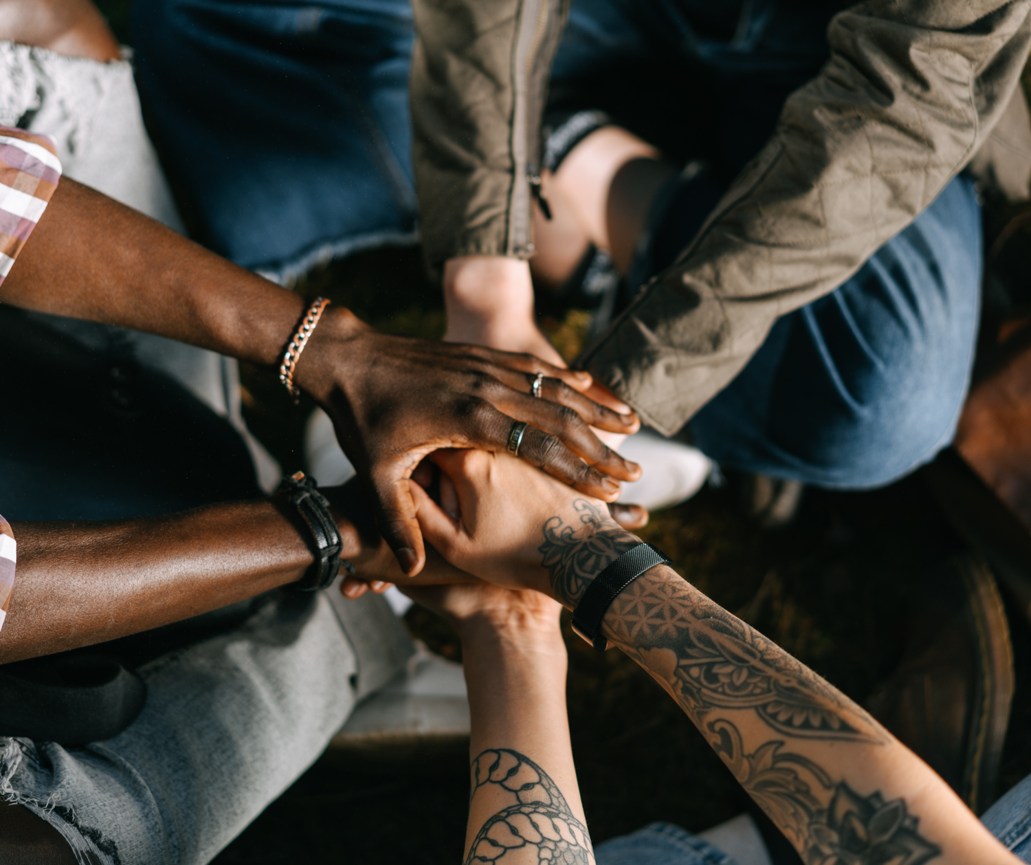 Hands join together in group setting.