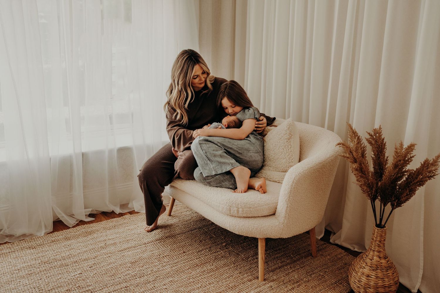 Modern minimalist nursery setting with family bonding on white furniture.