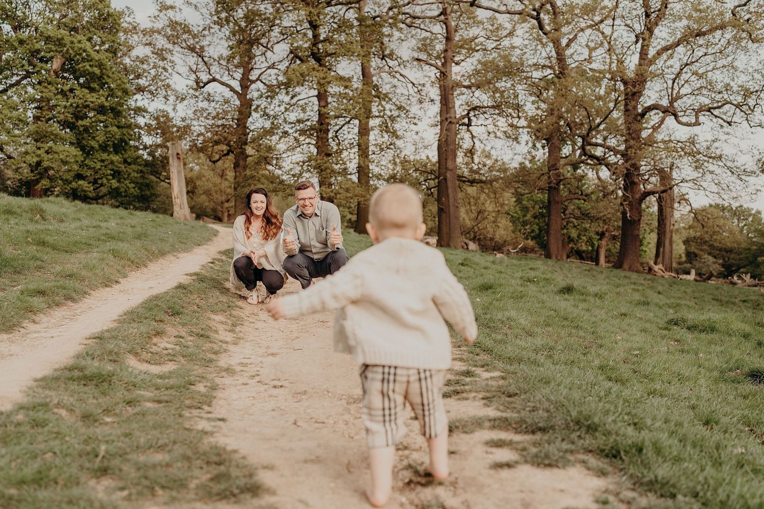 Family walking together on a scenic trail through a wooded park.