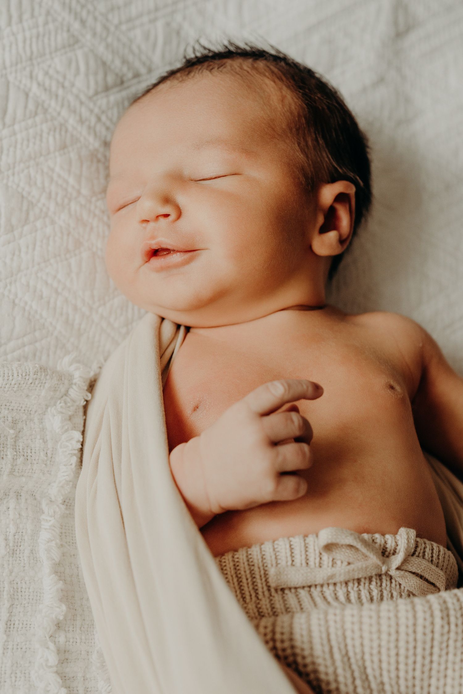 Close-up portrait of peaceful sleeping newborn baby in knit sweater.