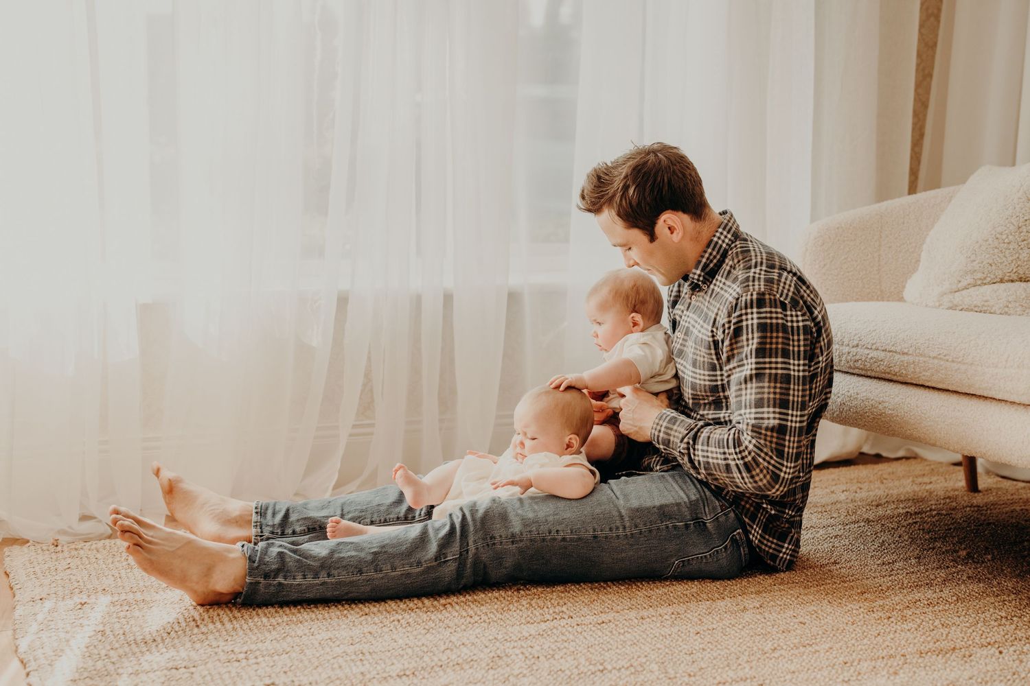 Family members lounging on carpet in casual indoor setting.