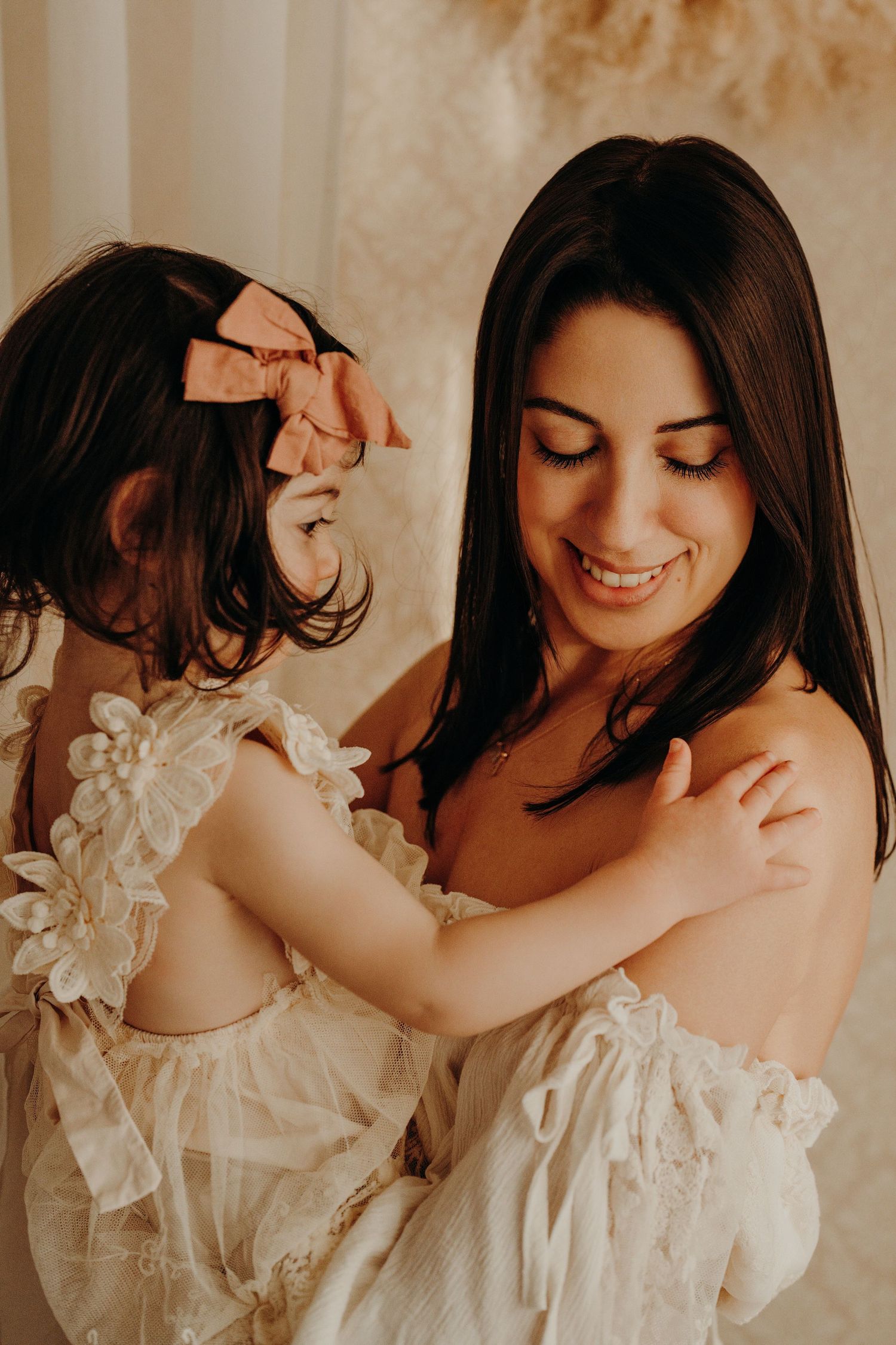 Intimate portrait session showing joyful moments in white lace dresses.