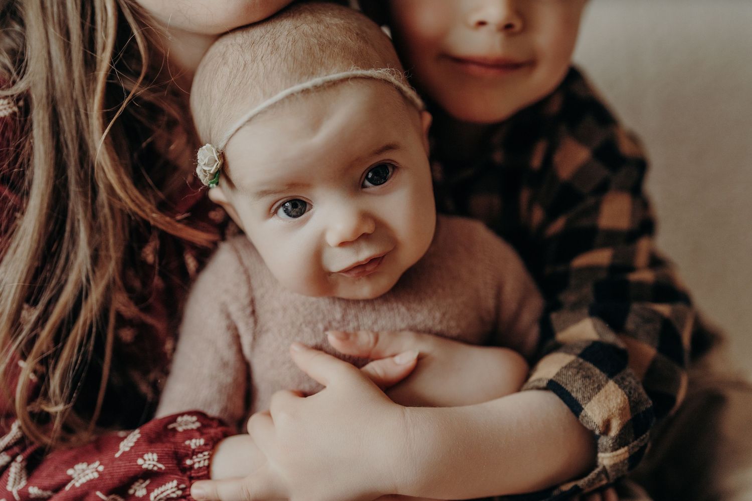 Intimate close-up lifestyle portraits in soft, warm indoor lighting.