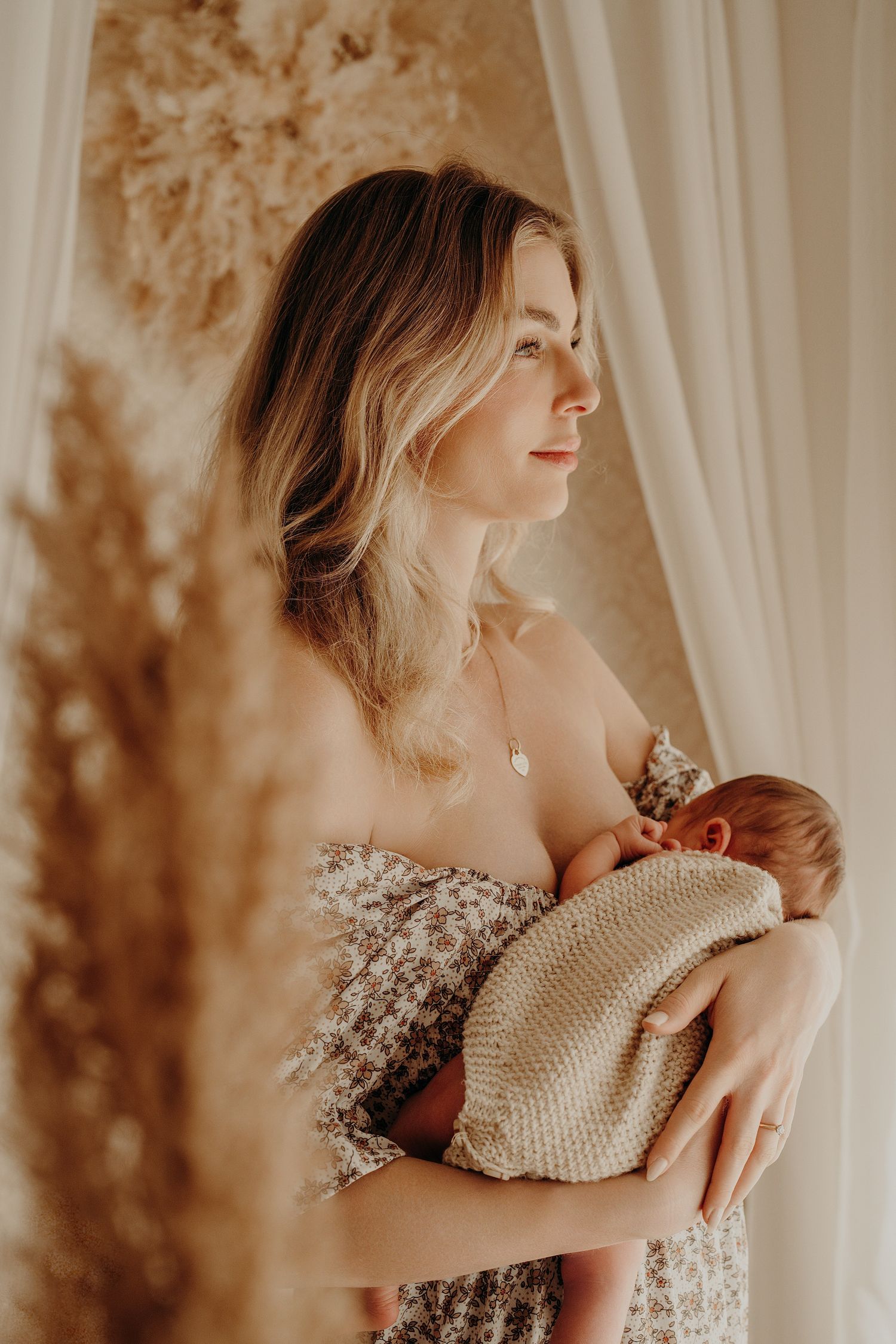 Ethereal portrait series with soft lighting and baby's breath flowers against white curtains.