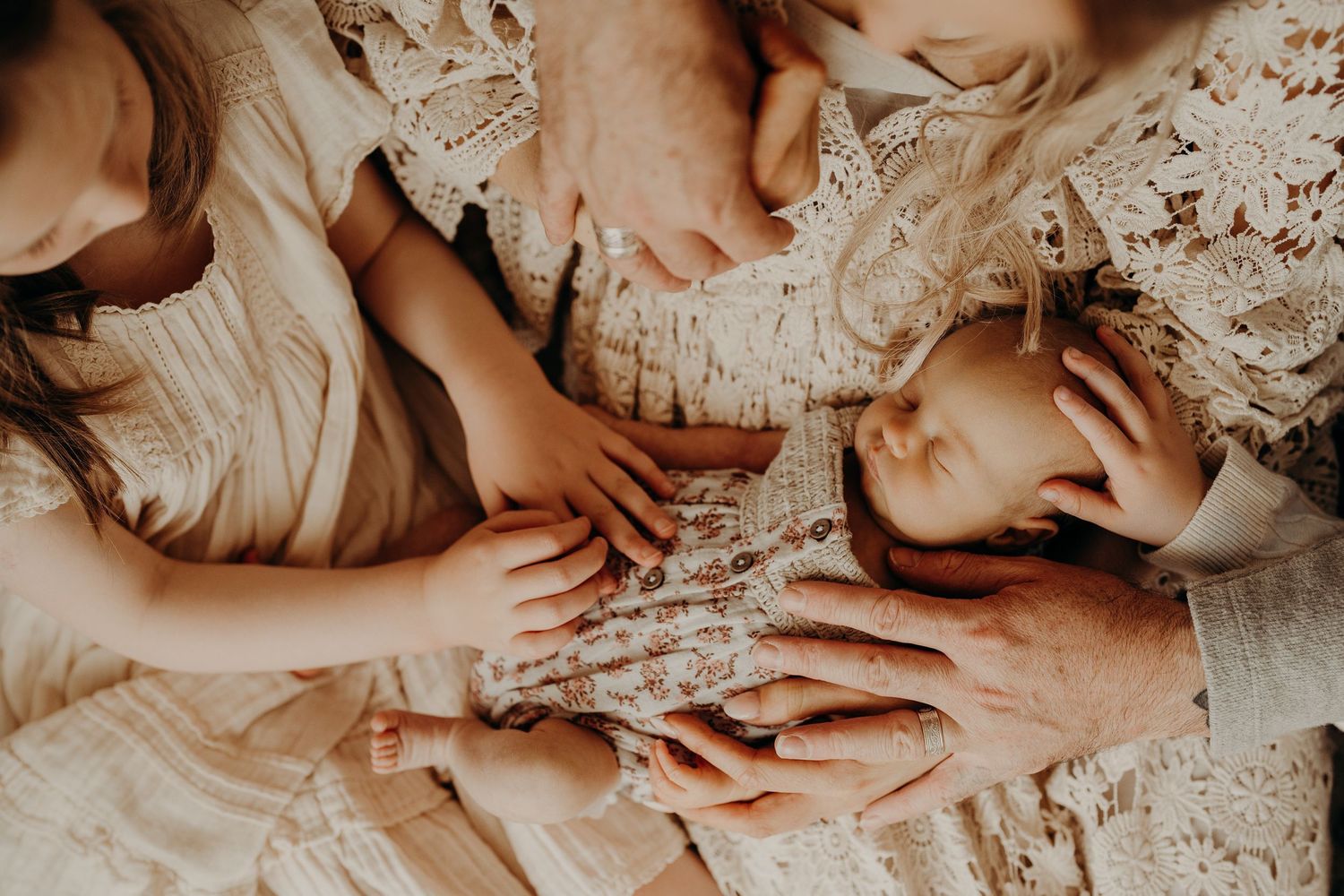 Artistic series of tender family moments captured in warm sepia tones.