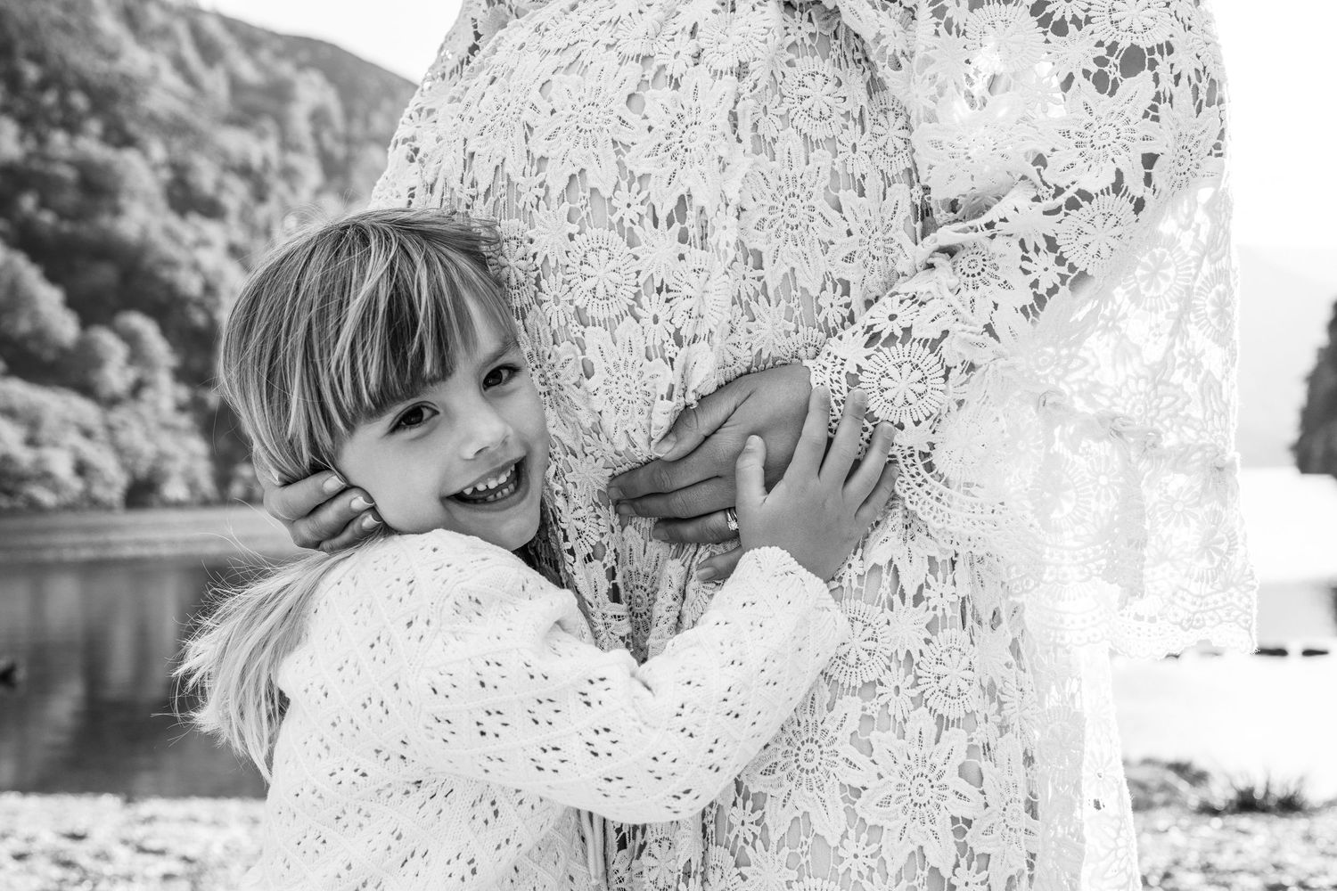 Black and white close-up portrait showing delicate lace details against natural backdrop.