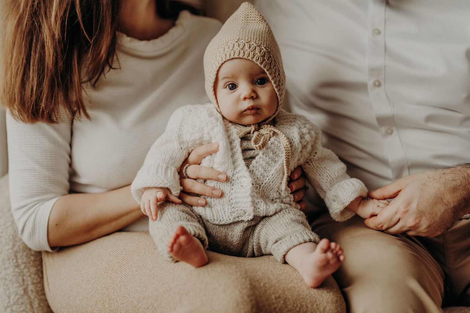 Lifestyle family photography session with newborn baby in neutral colors and natural light.