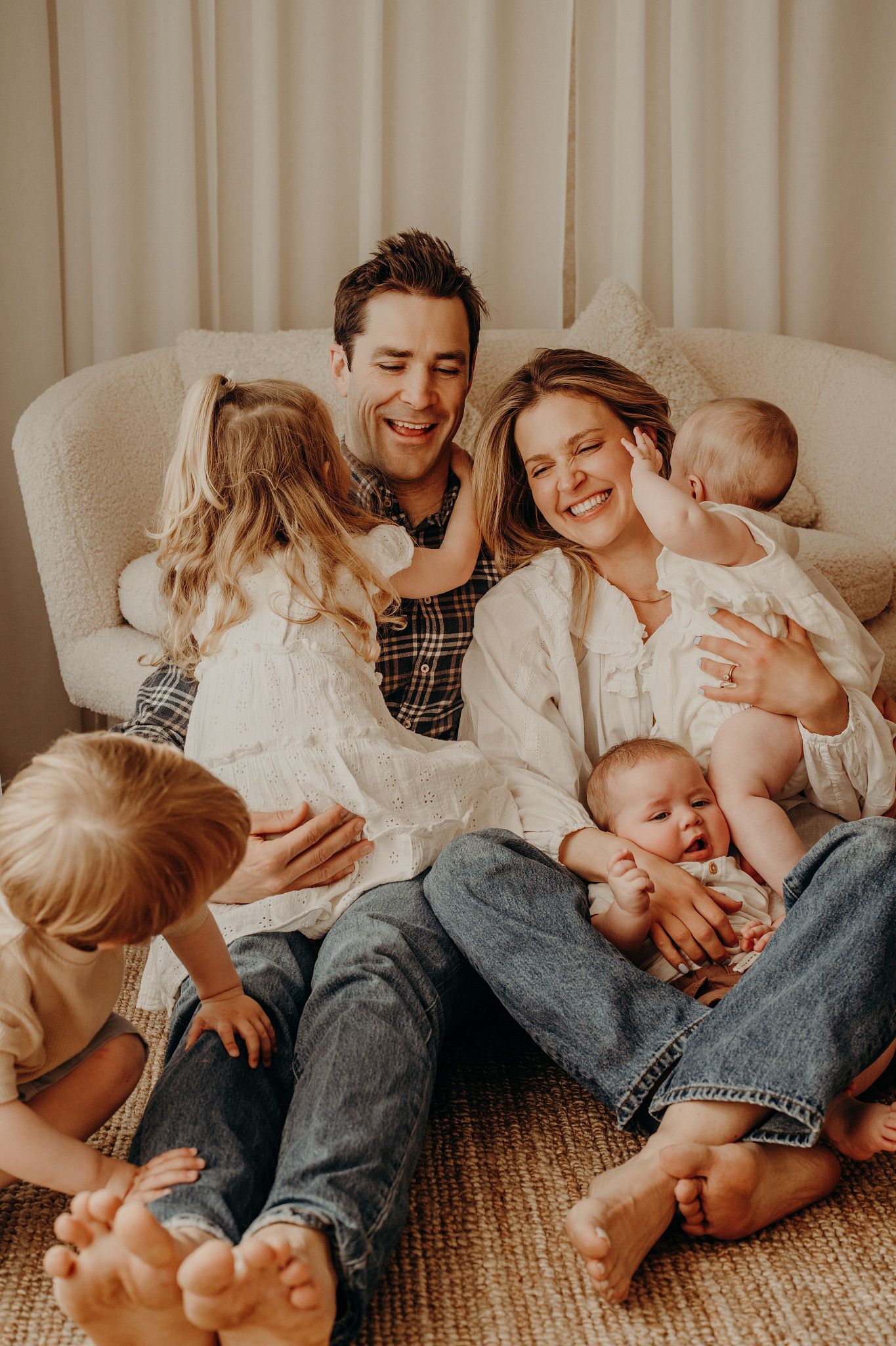 Relaxed family lifestyle photo showing casual moments together on a carpeted floor.