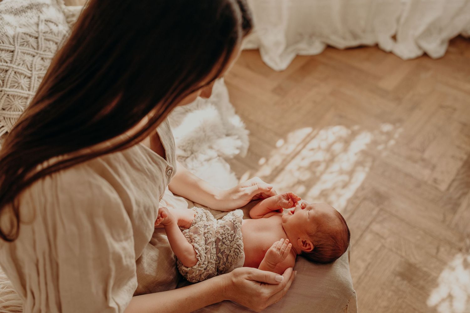 Peaceful newborn photography session with soft natural lighting and neutral tones.