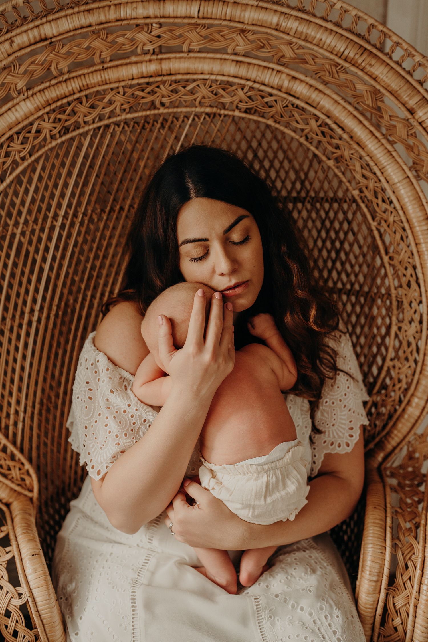Peaceful moment in ornate wicker chair with baby.