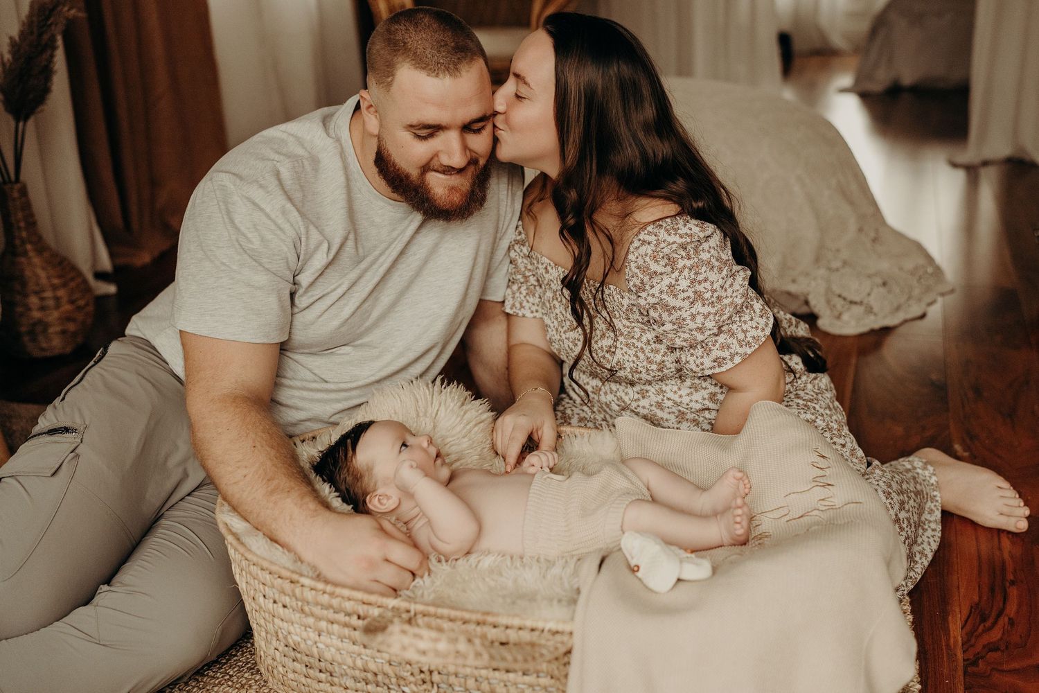 Family lifestyle session with newborn baby in white and neutral tones.