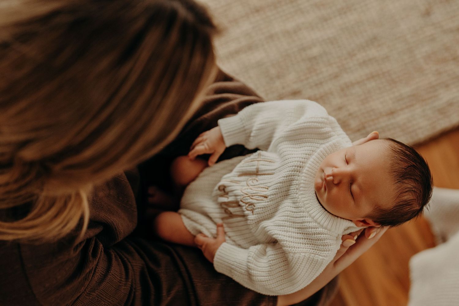 Soft focus images of sleeping newborn baby in natural window light.
