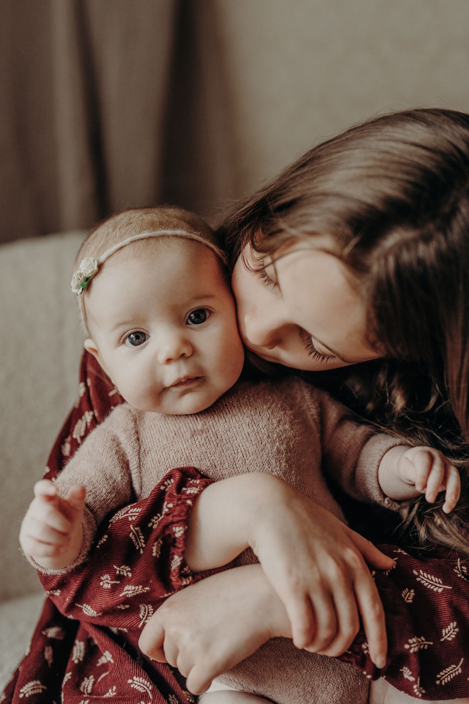Tender moment captured between family members in muted, warm tones.