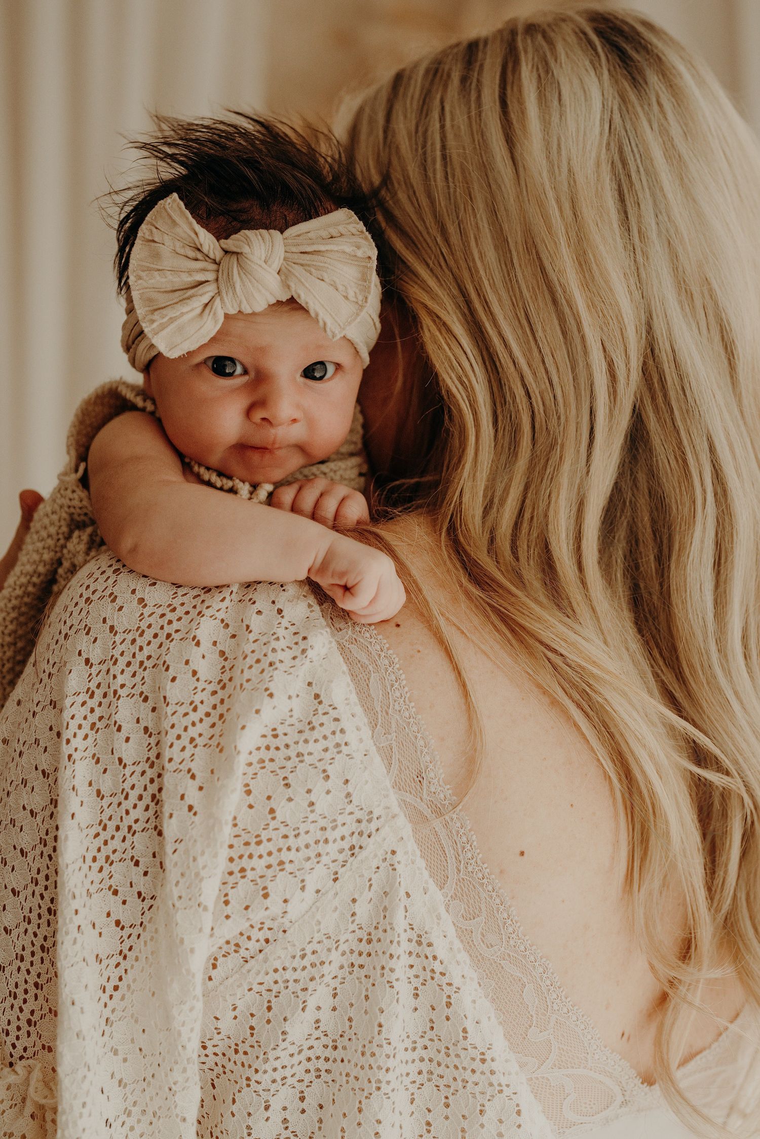 Intimate portrait series showcasing soft lace details and gentle expressions in warm lighting.