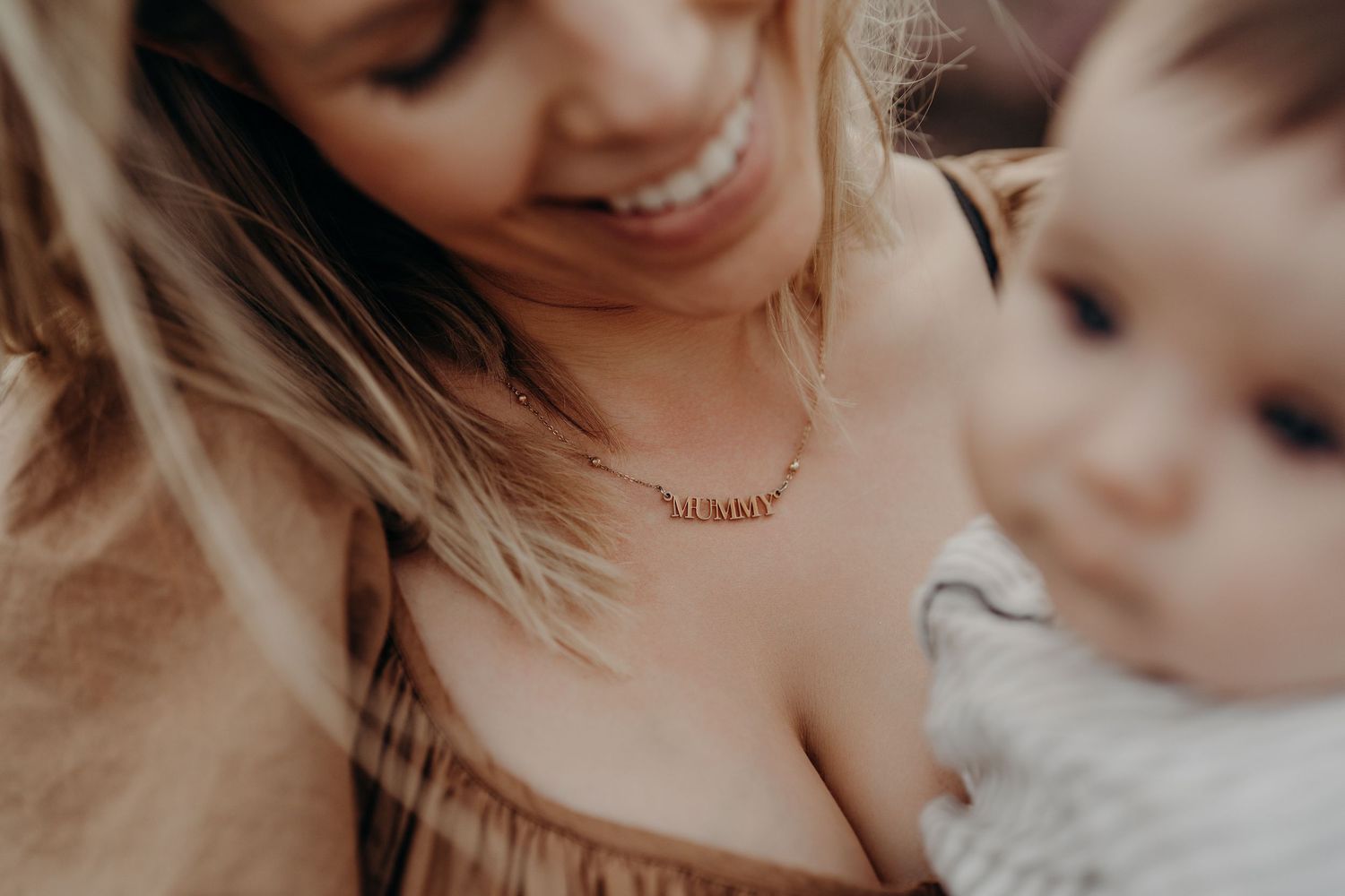 Intimate family lifestyle photography session showing tender moments in warm tones.