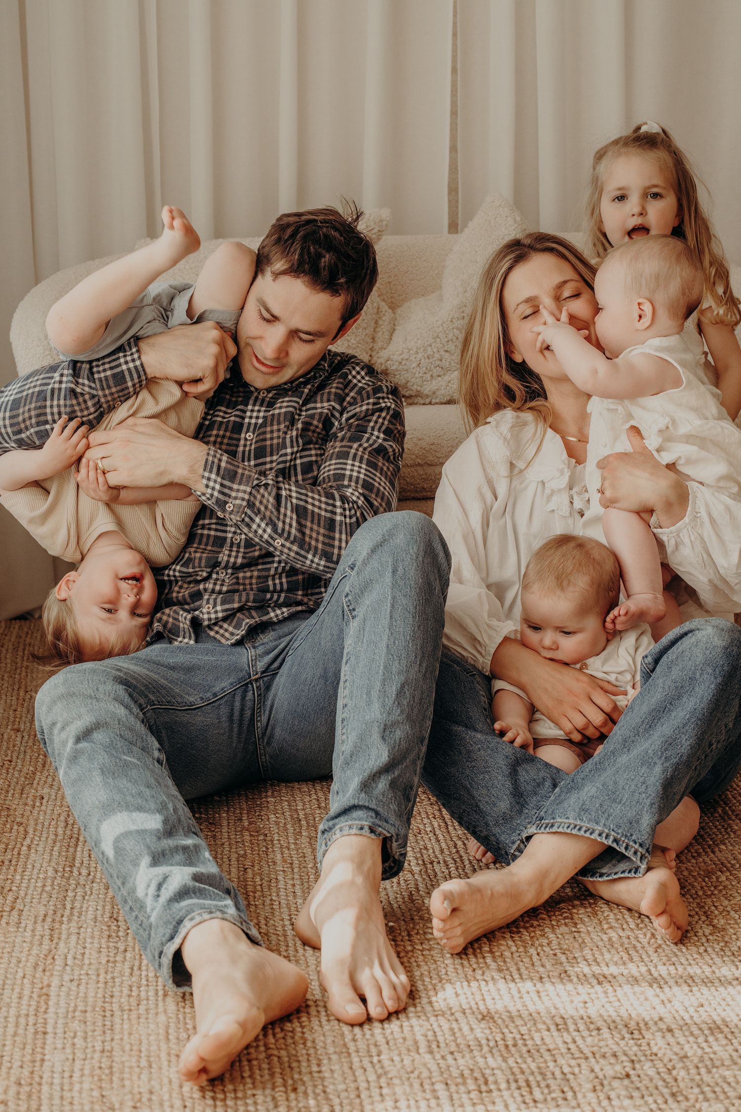 Family spending quality time together on beige carpet floor.