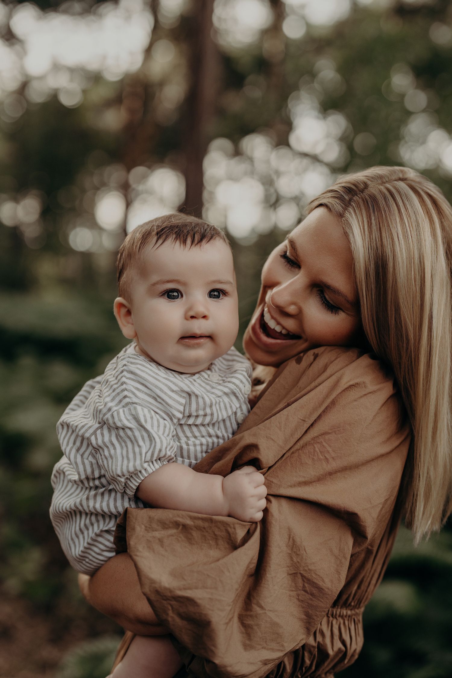 Intimate parent-child moments captured in soft bokeh lighting outdoors.