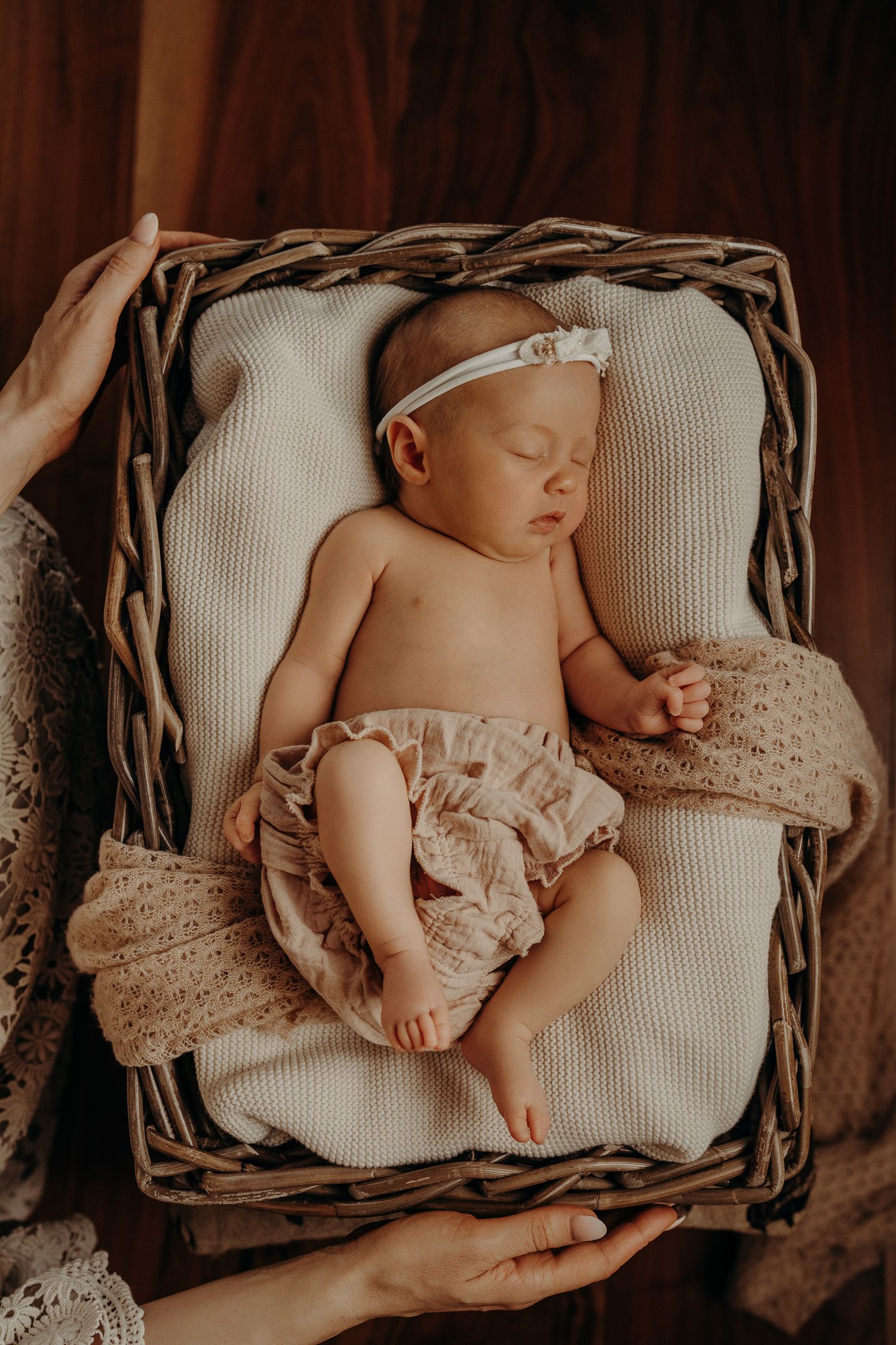 Serene newborn photography series in a rustic woven basket.