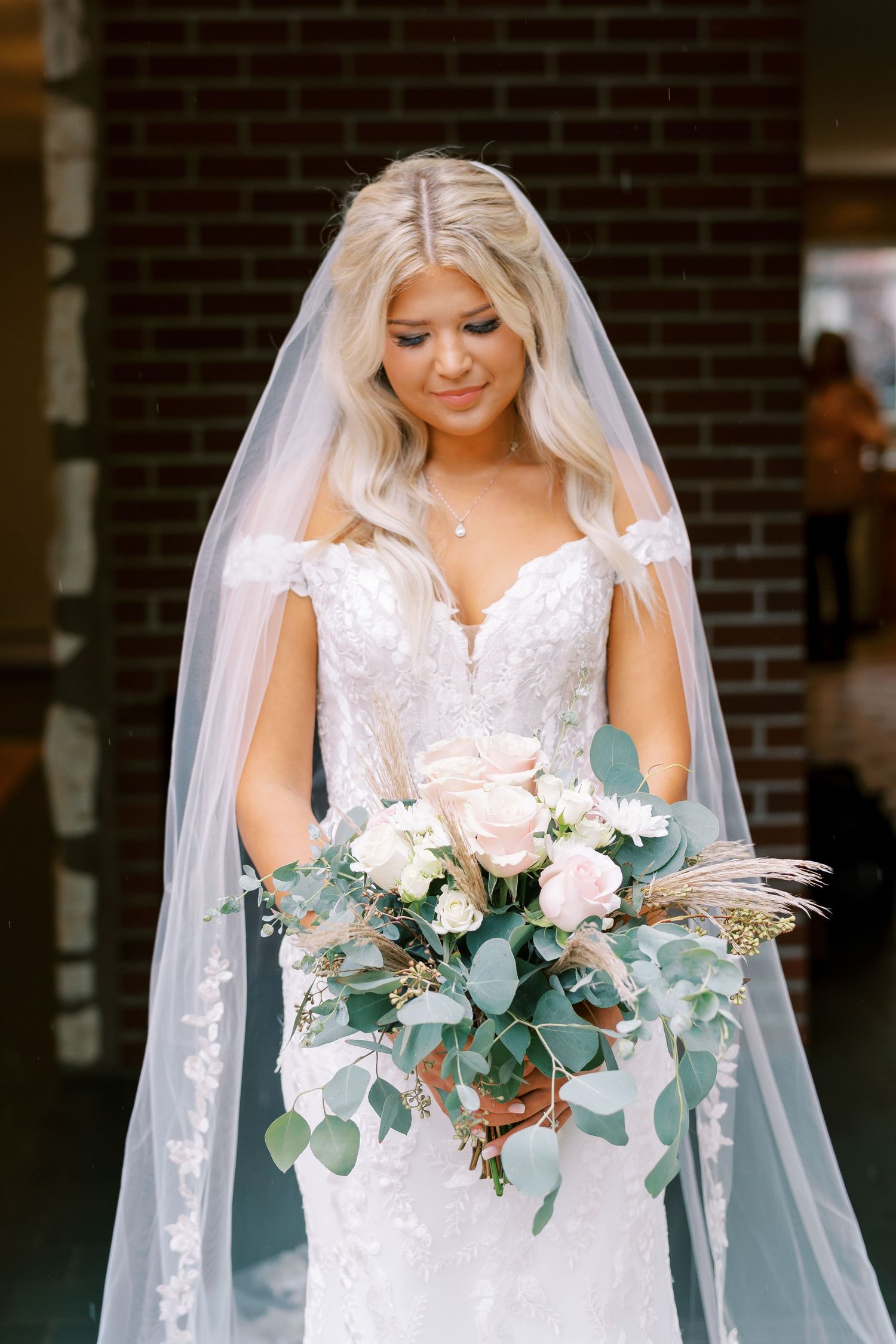 Bridal portraits showcasing lace wedding gown and pink and eucalyptus bouquet.