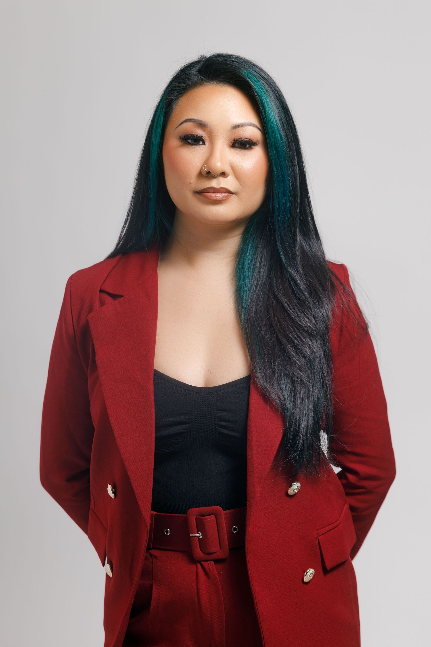 A series of fashion portraits showing a person in a red blazer and black top against a light gray background.