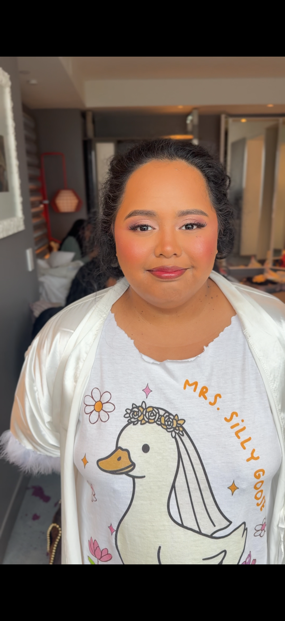 Wearing a white t-shirt with cute duck bride illustration and sparkle details.