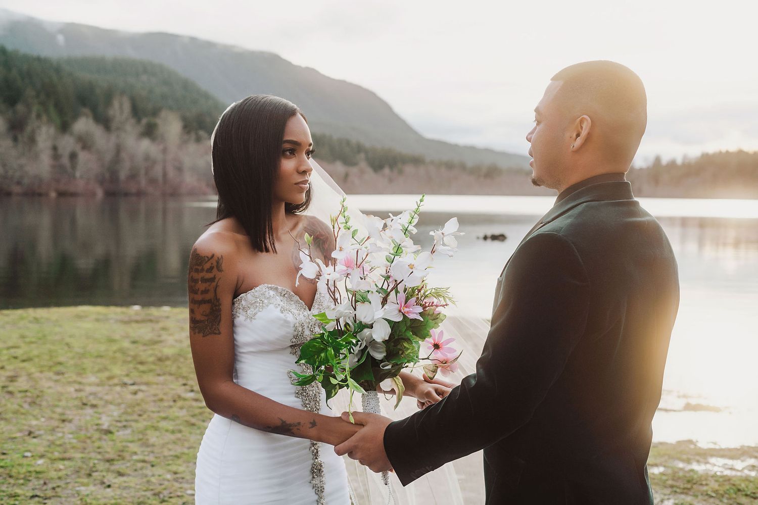 Wedding couple shares romantic moments during a lakeside photo session at sunset.