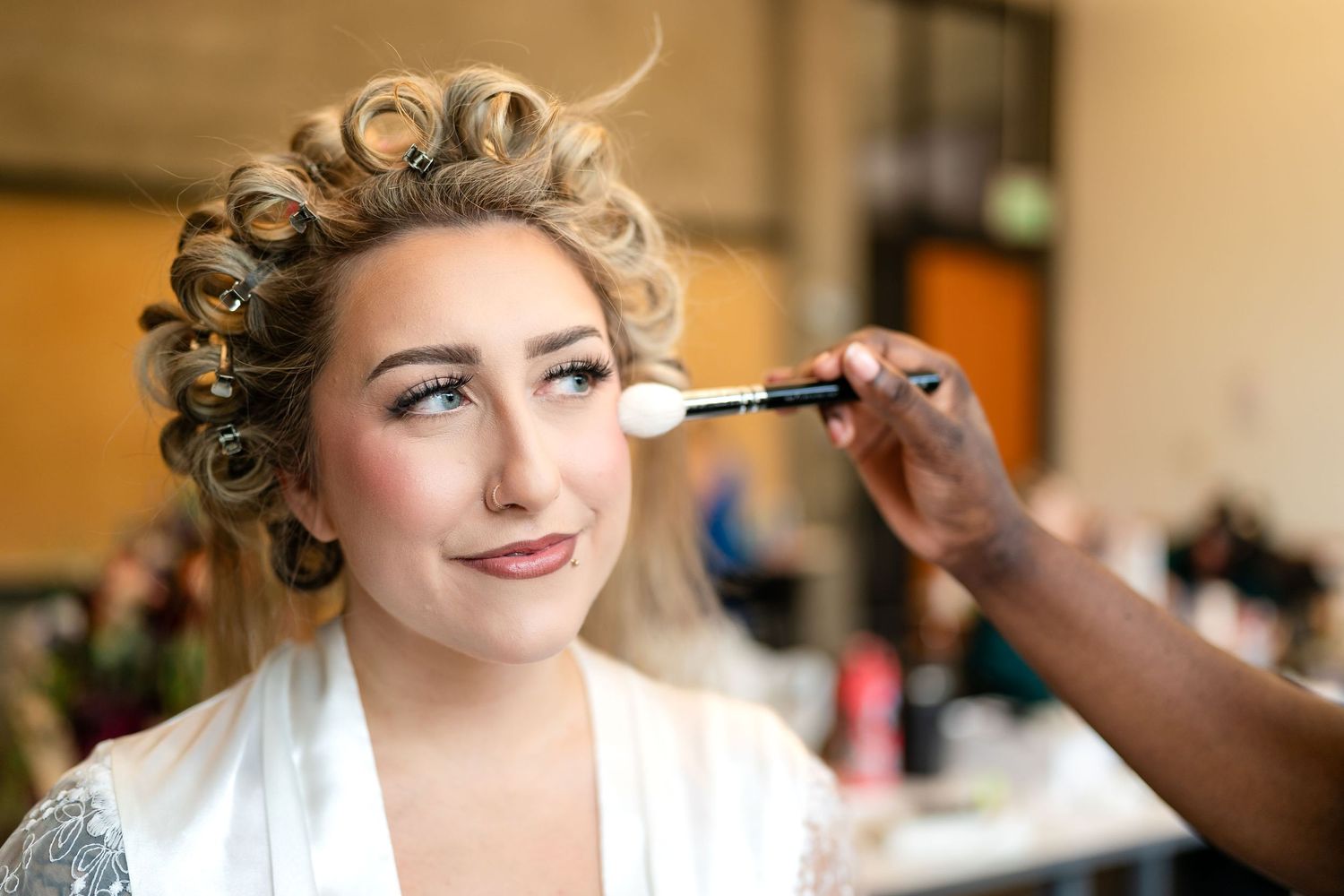 Close-up shots of bride getting makeup applied before wedding ceremony.