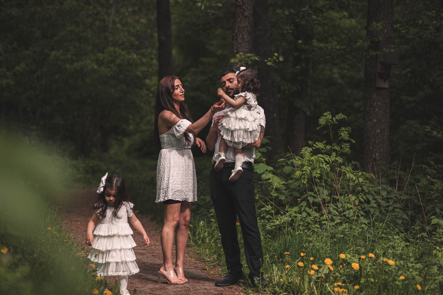 familj promenerar i skogen en varm sommar eftermiddag vid en fotografering i eskilstuna