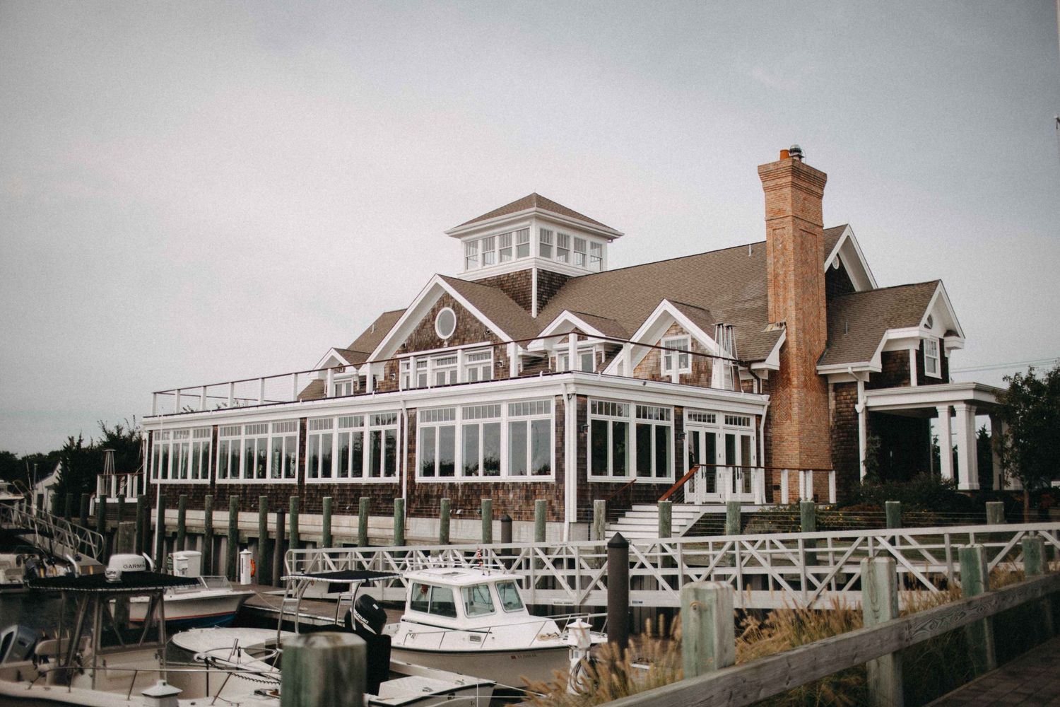 Charming waterfront venue with marina, boats docked, and classic New England architecture.