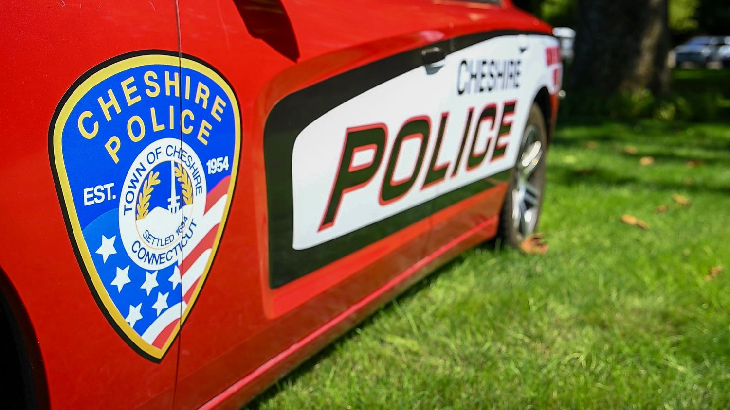 Cheshire Police department badge and logo on a red patrol car door in Connecticut.