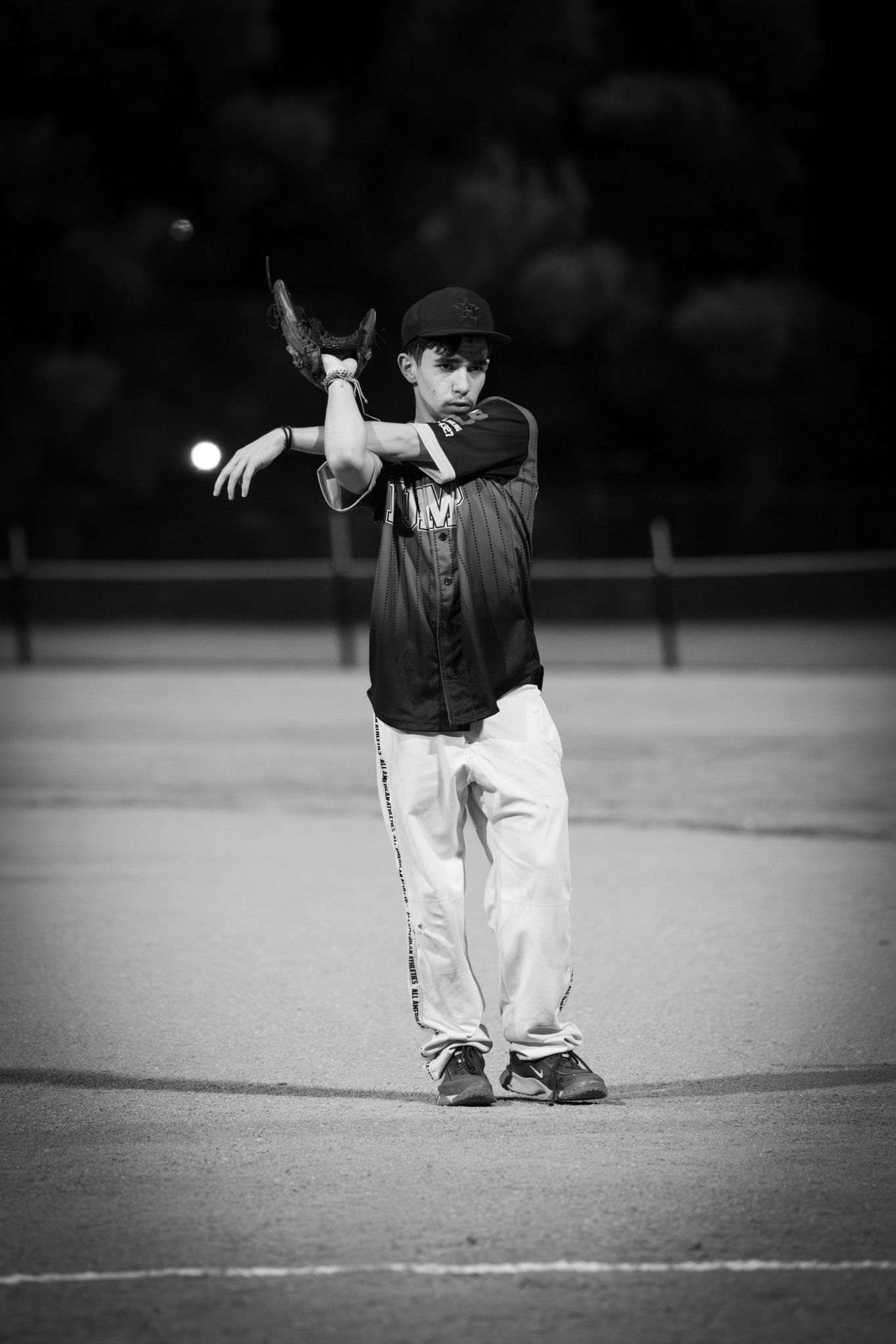 A series of black and white photos showing a young baseball player fielding a ball in progressive action shots.