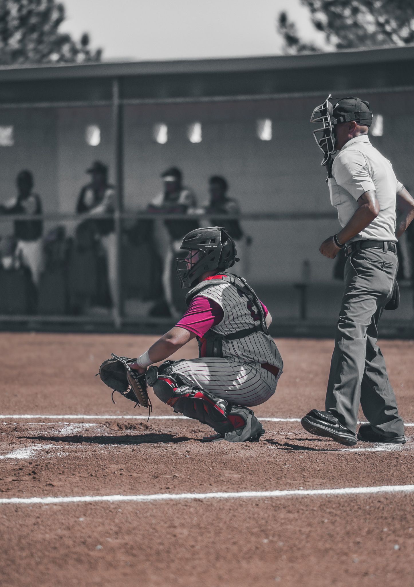 Baseball catcher in protective gear crouches behind home plate during a game, shown in multiple action frames.