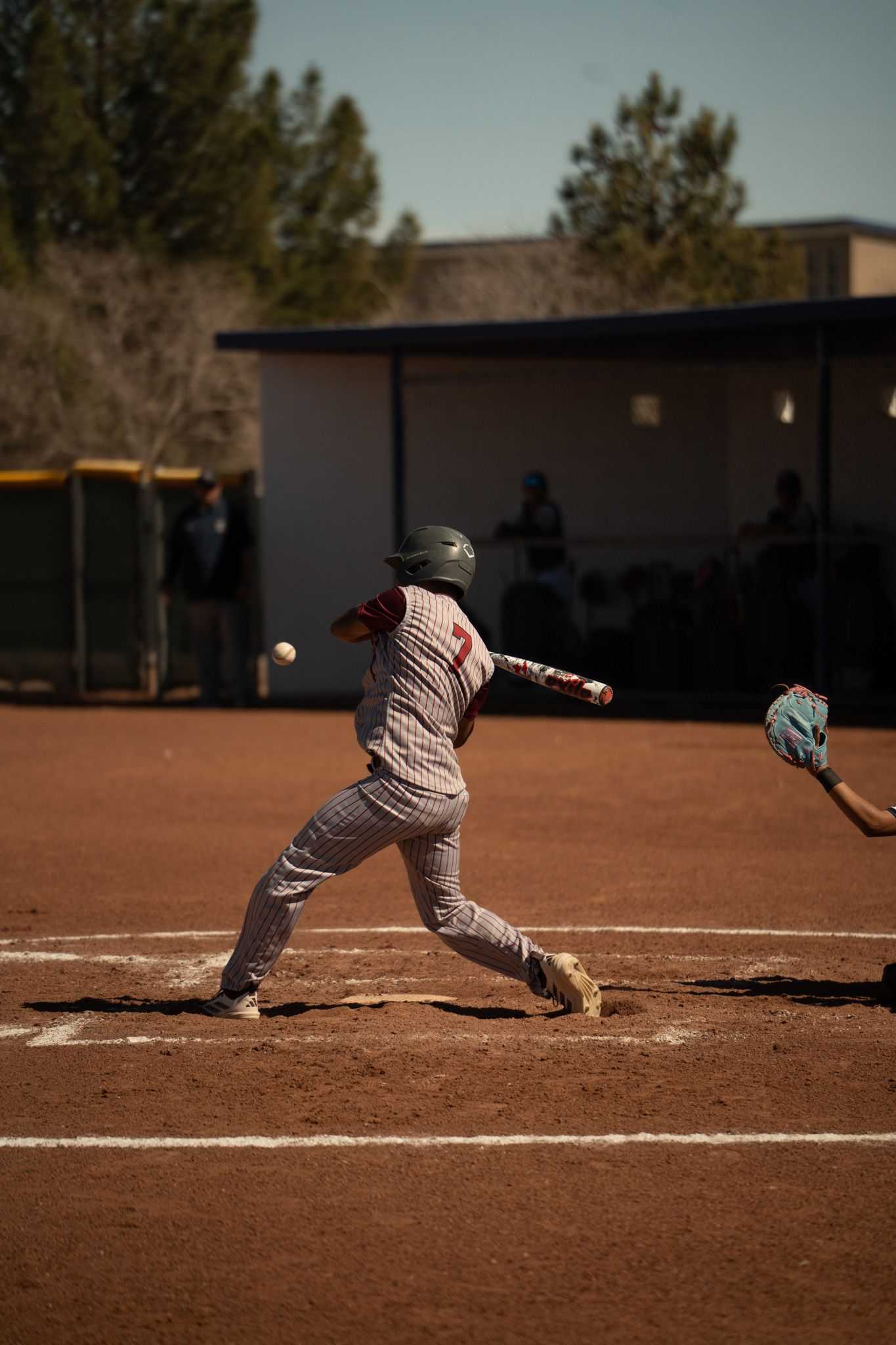 A sequence of baseball player sliding into base on a dirt field during a game.