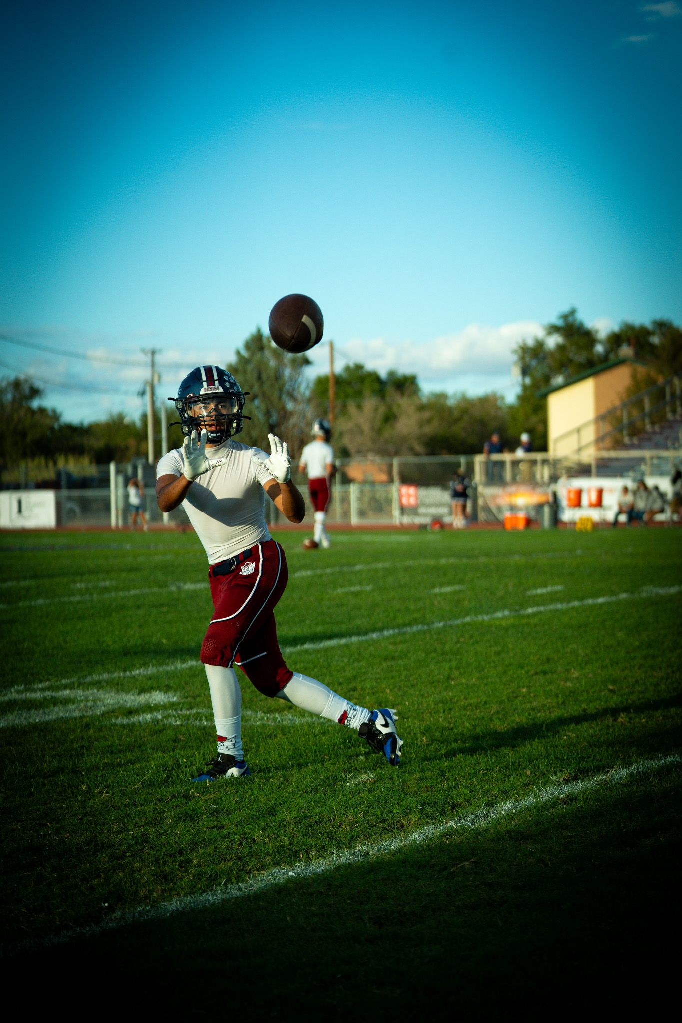 A sequence of football kicking action shots shows a player practicing field goals on a sunny day.