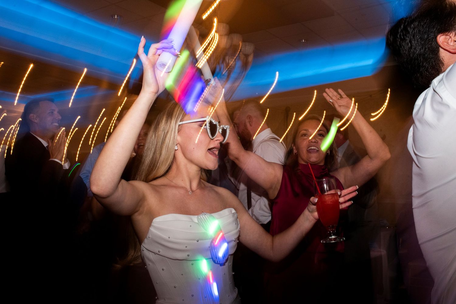Bride dances with glow sticks on the dance floor during her wedding reception at Lazaretto Ballroom in Pennsylvania.