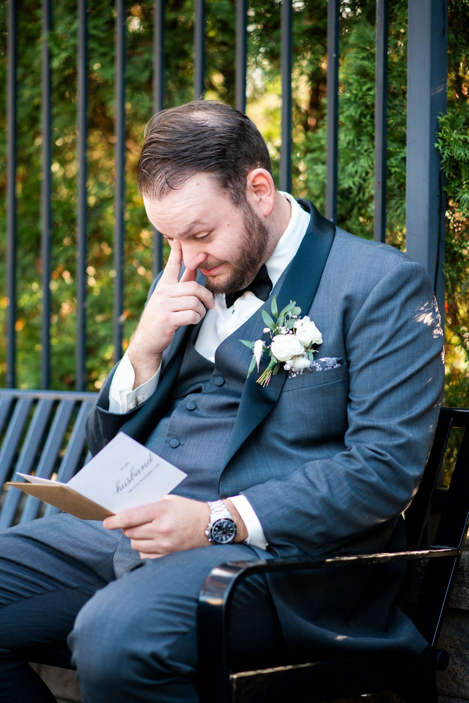 Groom wipes a tear as he reads a card from his future bride outside at Hamilton Manor in New Jersey.