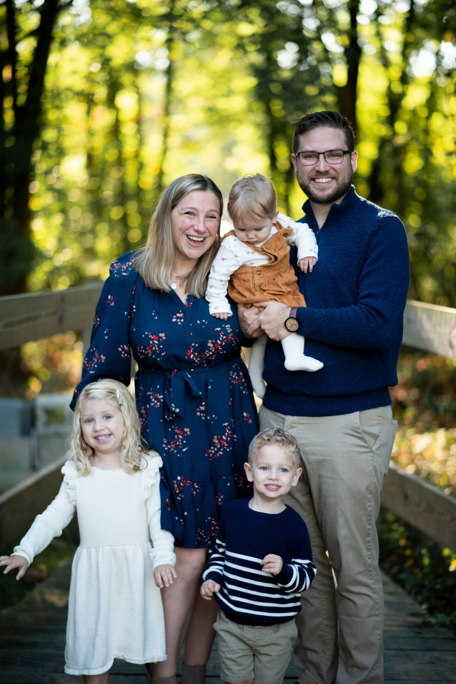 Family of five smile for portrait near the bridge at Croft Farm in Cherry Hill, NJ.