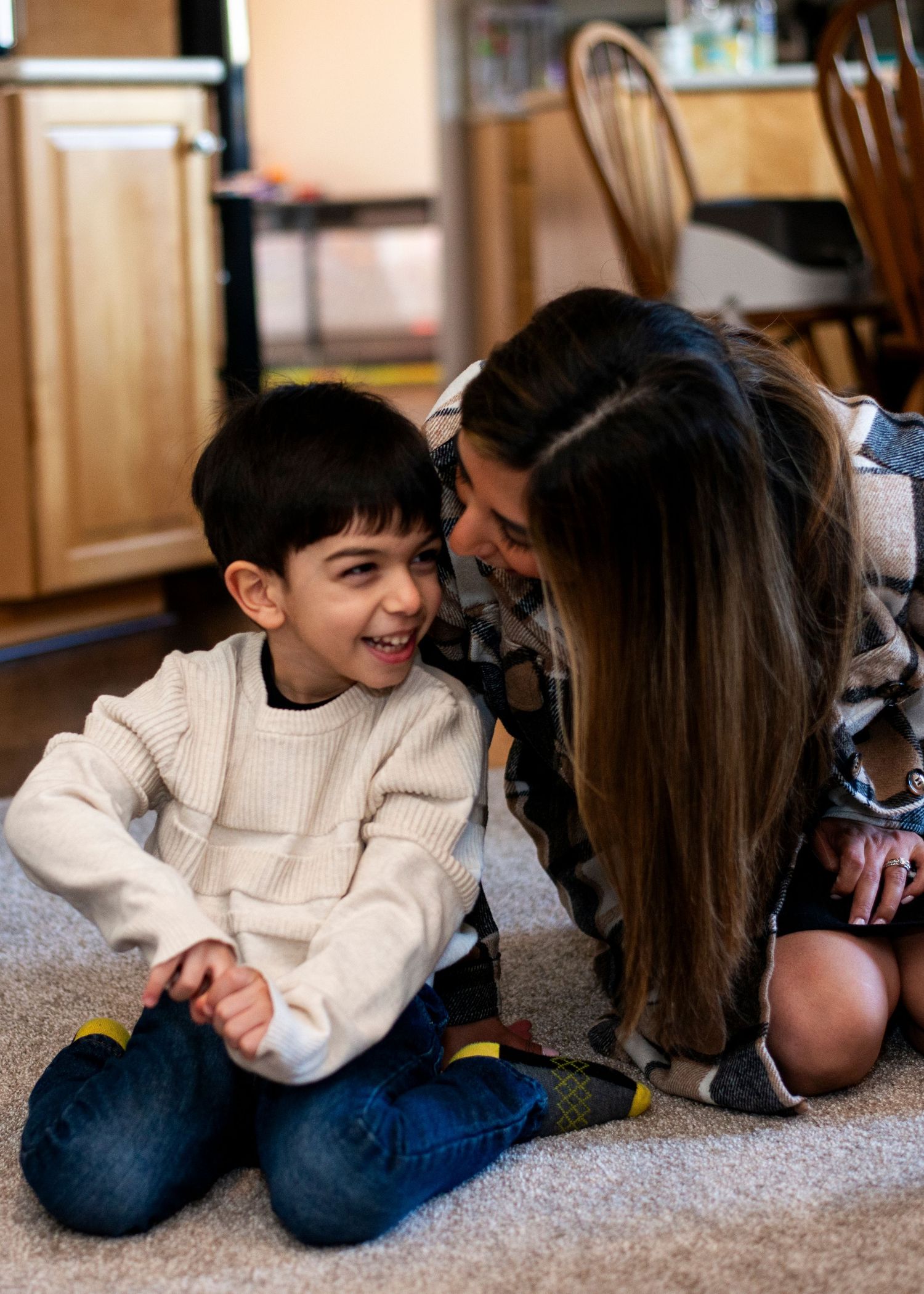 Mother and son play together on the floor at home in Cherry Hill, NJ.