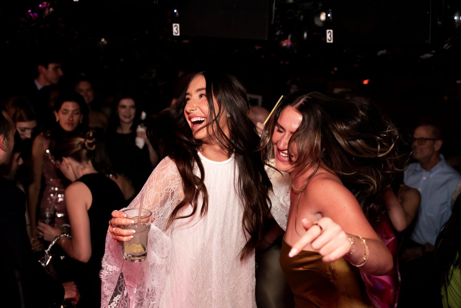 Bride dances with a friend on the dance floor at Cafe Wha? in New York City during her wedding reception.