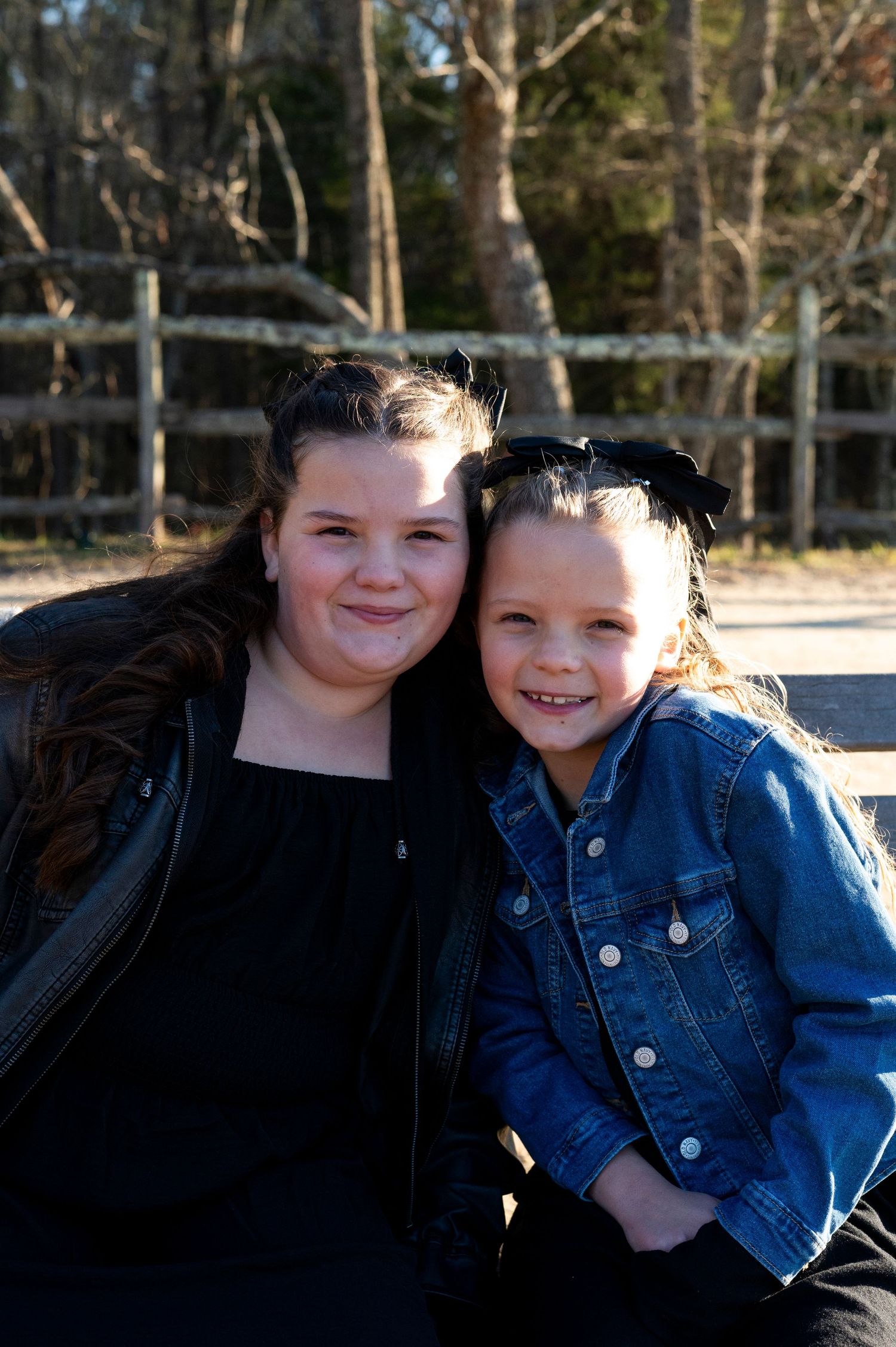 Two sisters smile with heads together at Batsto Historic Village in New Jersey.