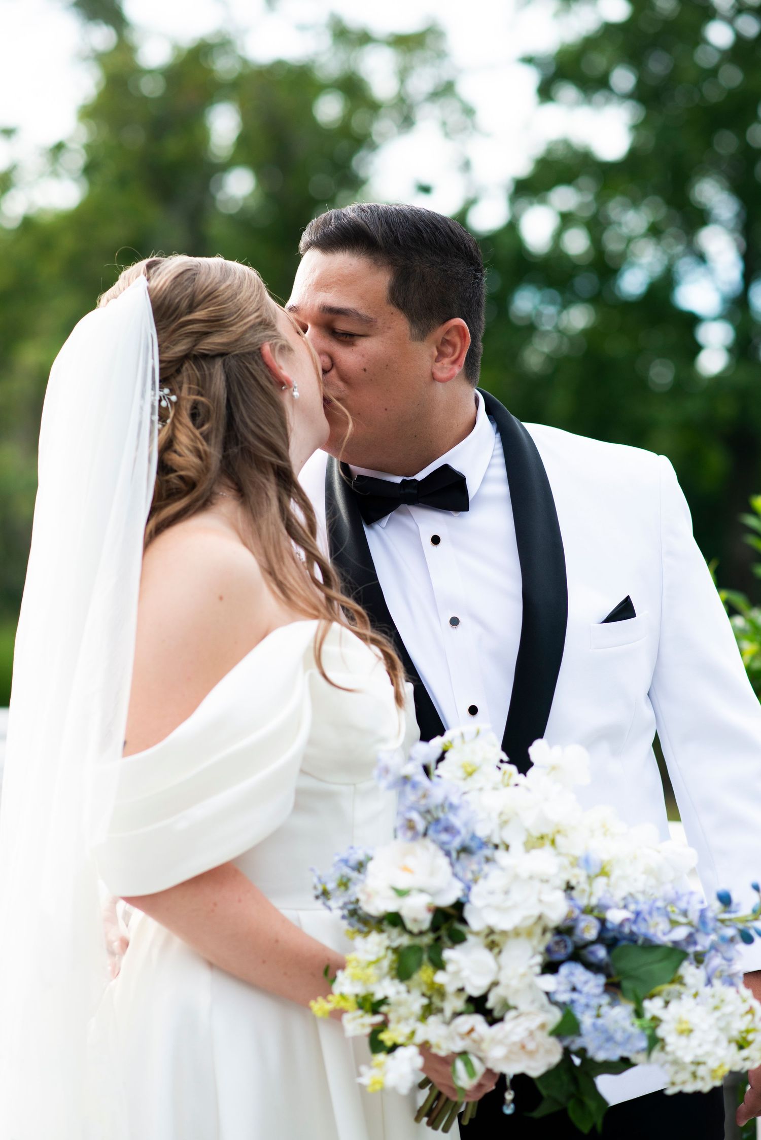 Bride and groom kiss after they exchange vows in the garden at the Mansion in Voorhees, New Jersey.